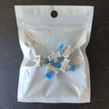 Mechanical keyboard switches in a clear plastic bag on a dark surface
